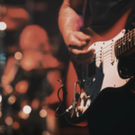 influential-musicians-performing-on-stage-with-vintage-microphones-guitars-lights-and-generational-music-energy