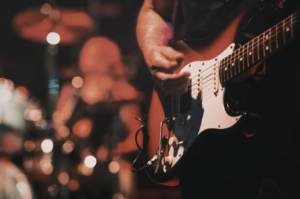 influential-musicians-performing-on-stage-with-vintage-microphones-guitars-lights-and-generational-music-energy